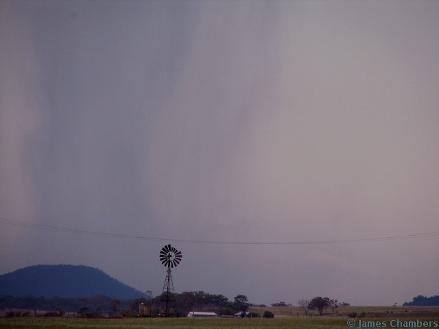 Rain begins to fall out of the base - behind a dodgy windmill